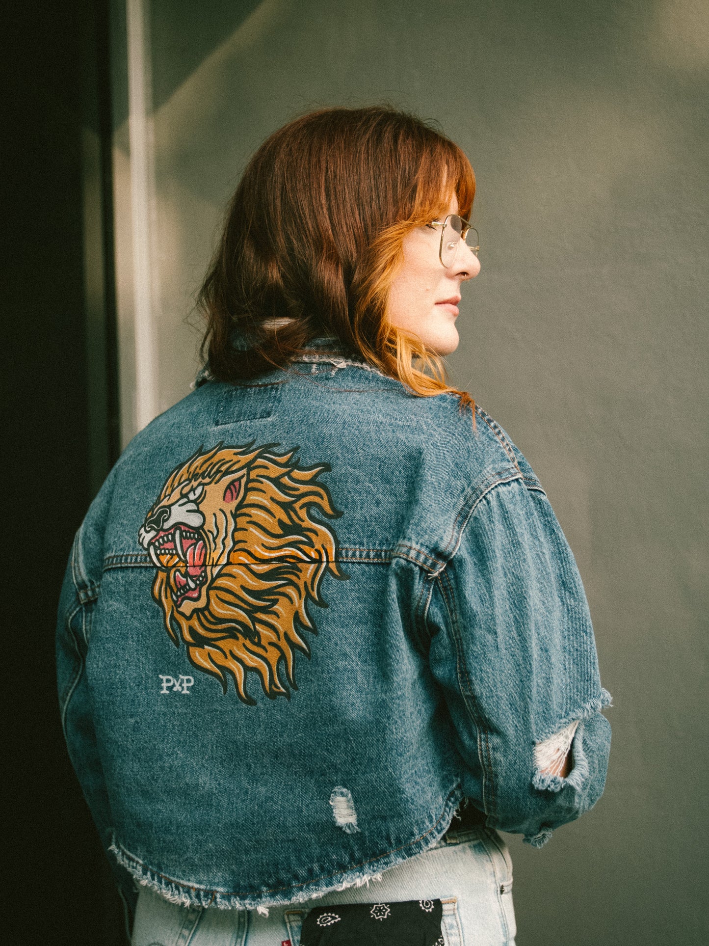 The Lion destroyed dark denim jacket