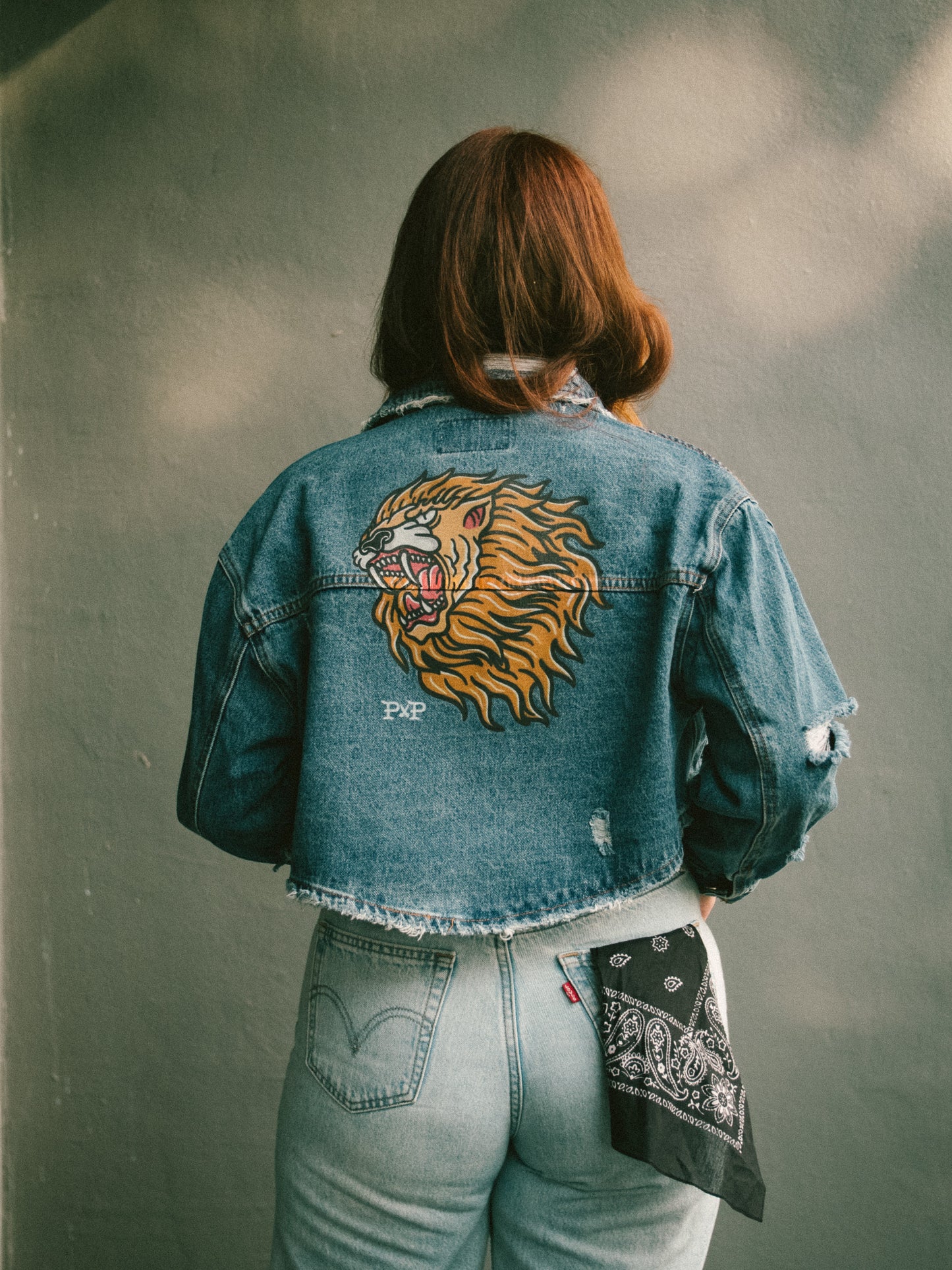 The Lion destroyed dark denim jacket